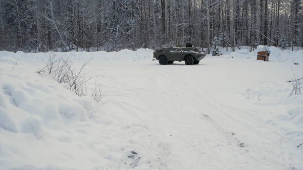 Tank or armored personnel carrier in winter forest. Clip. Shot from a grenade launcher on the tank in the winter forest. The attack on the APC with a grenade launcher