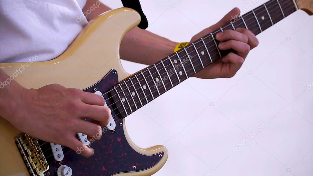 Close Up Of Man Playing Amplified Acoustic Guitar. Clip. Close-up view of hand playing guitar. Musician play on bass guitar