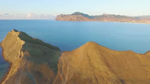 Top view of the cliff by the sea. Shot. Beautiful view of the mountain area by the sea at sunset — Stock Video