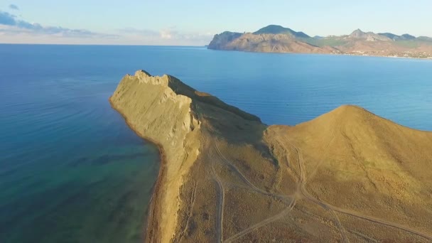 Top view of the cliff by the sea. Shot. Beautiful view of the mountain area by the sea at sunset — Stock Video