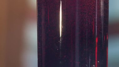 Gaz kabarcıkları float koyu mavi sıvı ile plastik şişede. Kırmızı sıvı plastik şişe kabarcıkları ile görünümü kapatın