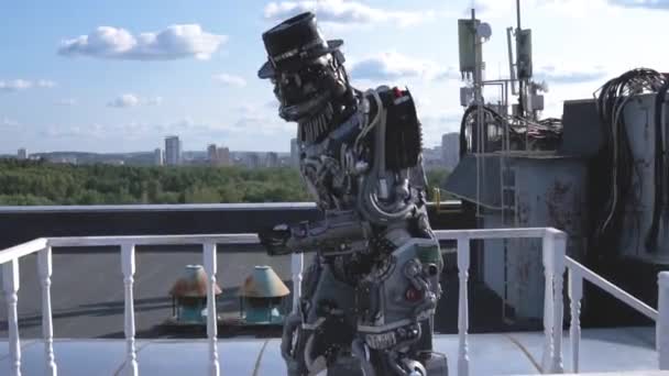 Robot moves his hands on background of city skyline and blue sky. Footage. Concept of technologies with artificial intelligence — Stock Video