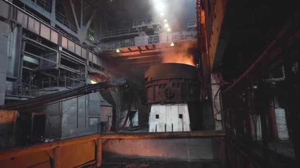 View of smelting of metal with ladle inside foundry. Footage. Interior of dirty metallurgical plant in dark. Concept of heavy industry — Stock Video