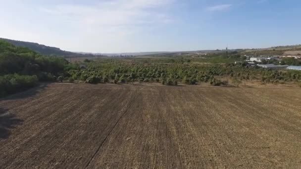 Aerial view of agricultural fields in the mountains with blue sky background. Shot — Stock Video