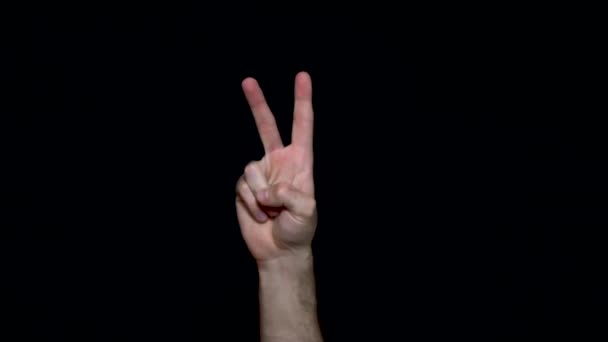 Hand showing victory sing on black background. hand peace or victory sign or fighting. — Stock Video