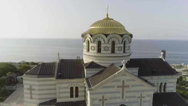 Bekijken van de grote witte kerk met gouden koepels voor prachtige rivier, spring Vologda, Rusland. Schot. Mooie luchtfoto van de vogels eye weergave voor de grote kerk aan de rivieroever. — Stockvideo