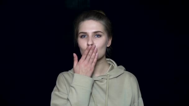 Young woman sending air kiss. Human facial expressions and emotions. Black isolated background — Stock Video