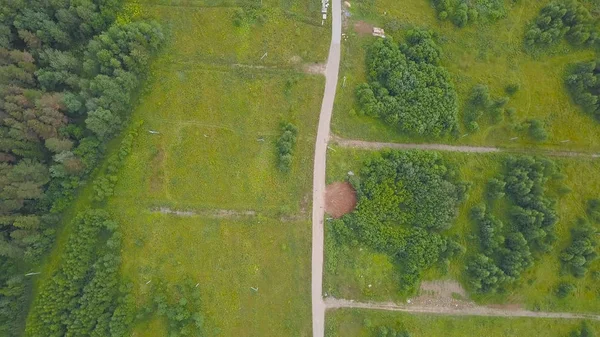 Bovenaanzicht van snelweg met landelijke weg tussen bos. Clip. Highway loopt langs landelijke bosrijke omgeving — Stockfoto