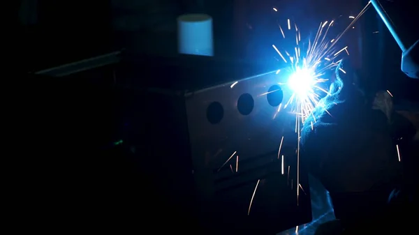 Industrial worker welding, slow motion. Clip. Metal Welding Close-Up in super slow motion. Close-up. Welder in protective clothing working with metal, welding metal. Slow motion.