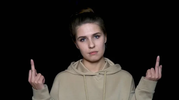 Beautiful girl showing middle finger, isolated on black background. Angry hipster woman showing middle finger — Stock Photo, Image