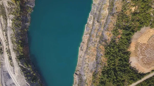 Amazing views over the trees and lakes during the Autumn season. Shot. Top view on Azure shore of a lake with forest landscape. Aerial view of amazing sunset over the nature park