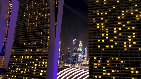 Singapur - 25 de septiembre de 2018: Marina Bay Sands hotel en Singapur iluminado por la hermosa iluminación púrpura y el espectáculo de láser por la noche. Le dispararon. Avanzando hacia la impresionante Marina Bay arenas por la noche con — Foto de Stock