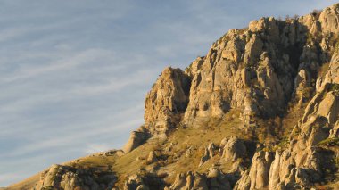Hava güneşli akşam mavi gökyüzü arka plan üzerinde güzel bir dağ için. Vurdu. Profil bulutlu mavi gökyüzü arka plan üzerinde sonbahar güneşli akşam sarp kayalarda.
