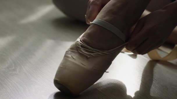 Close-up of ballerinas feet. Close-up of calloused, bandaged with patches, feet ballerina sitting on floor and preparing for another grueling workout — Stock Video