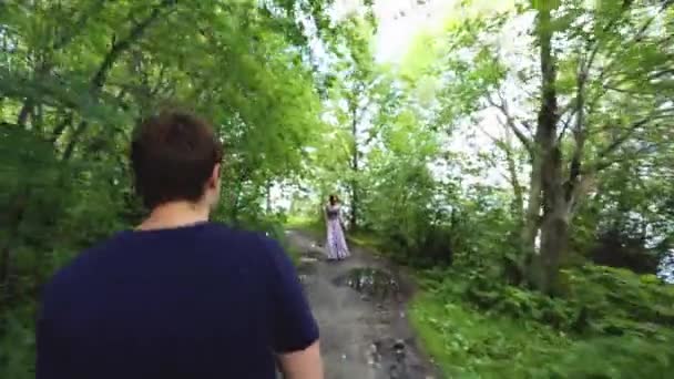 Man en vrouw op wandeling in de bossen. Vreemden man en vrouw botste op wandeling langs het bospad in de zomer — Stockvideo