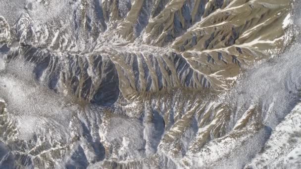 Colorful landscape of snow-covered mountains. Shot. Top view of the hilly landscape in winter — Stock Video