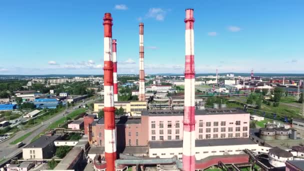 Aéreo para chaminés de fábrica e a paisagem urbana em um verão, dia ensolarado. Filmagem. Zona industrial na cidade em azul, fundo céu nublado . — Vídeo de Stock