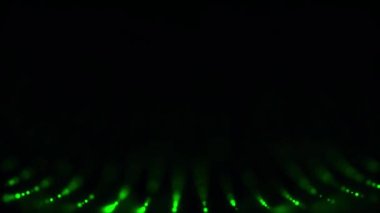 Soyut, sarı, küçük daireler siyah arka plan üzerine, sorunsuz döngü dalgalar gibi düzenli bir şekilde hareket eder. Renkli noktalar dairesel hareket ve karanlıkta kaybolur.