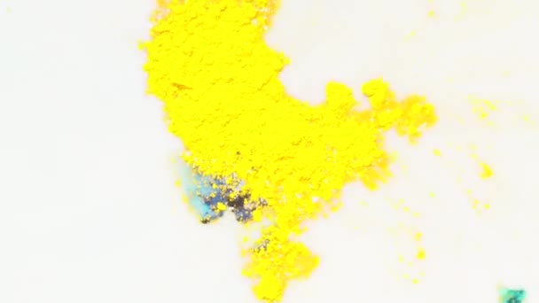 Close-up of colorful stains on the white liquid and multi-colored pattern. Yellow food colors in the milk. — Stock Video