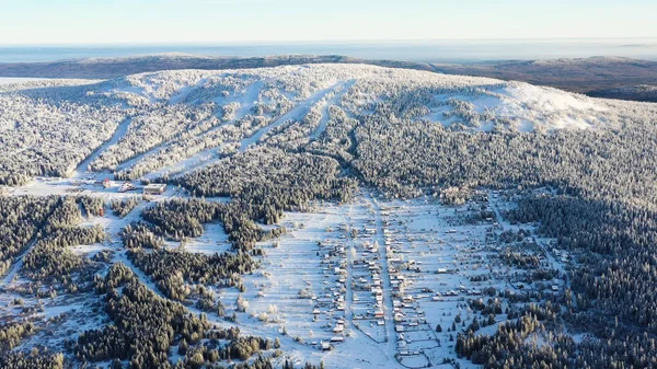 Панорамний вид зверху на гірськолижний курорт. Кадри. Прекрасний зимовий пейзаж гірськолижного курорту в лісовій гірській місцевості. Активний відпочинок взимку — стокове фото