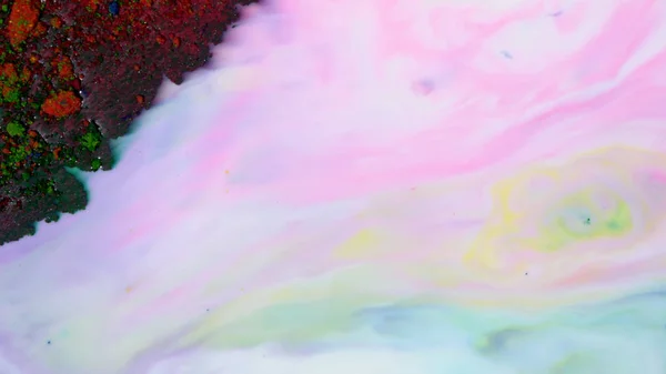 Rainbow stains on milk. Colorful pastel colors paint streaks on surface of milk. Dark powder paint hardened on surface of milk — Stock Photo, Image