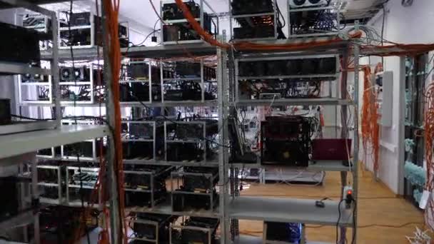 Mining farm with wires. Close-up of hanging colored wires on racks with equipment for cryptocurrency mining farm — Stock Video
