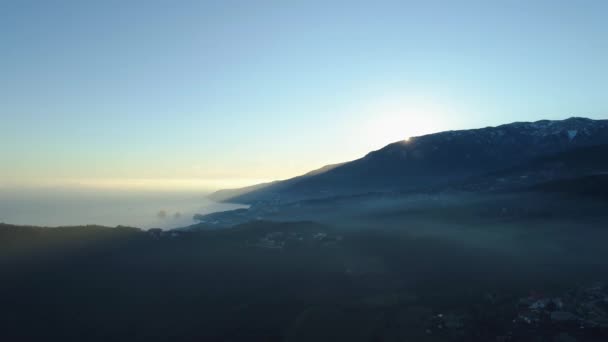 Top uitzicht op het berglandschap met zee en zonsopgang van de heldere hemel. Schot. Prachtige schilderachtige berglandschap met zee en stad in de ochtend mist — Stockvideo