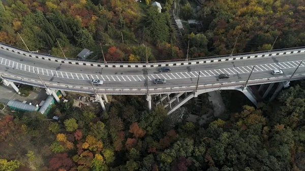 Vista superior no viaduto com carros de condução, mar e bela paisagem de fundo. Vista aérea da rodovia e viaduto na cidade. Junções rodoviárias — Fotografia de Stock