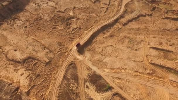 Aerial view of the large red truck moving on a sandy track in desert. Desert trip. — Stock Video