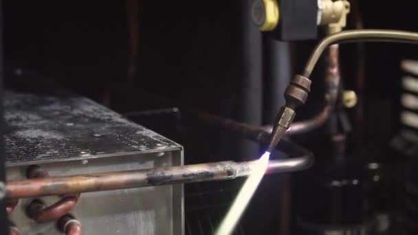 Close-up on blow torch fusing copper tube together with solder. Clip. Close-up shot of a man welding a pipe — Stock Video