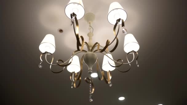 Luxury Chandelier. Close-up shot of modern lighting lamp with light bulbs on on a ceiling — Stock Video