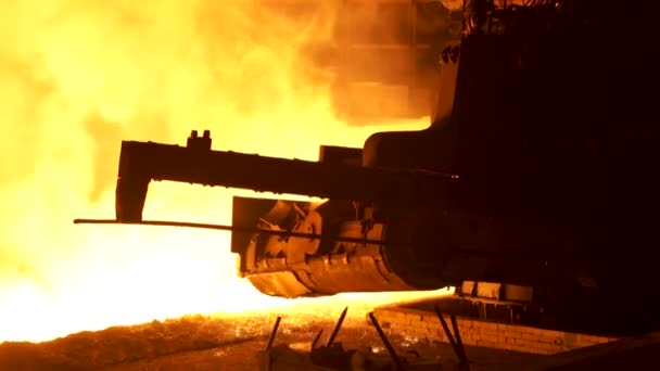 Molten metal pouring from the special mechanism, metallurgy concept. Molten steel flowing in metallurgical chute behind moving mechanism. — Stock Video