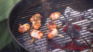 Izgara sosis pastırma ile. Sosis pastırma ile ızgarada kızartılmış. Sosis pastırma Barbekü doğada hazır sarılmış
