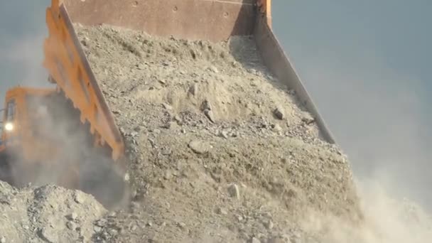 Close-up of the limestone ore unloading from mining truck. View from back. — Stock Video