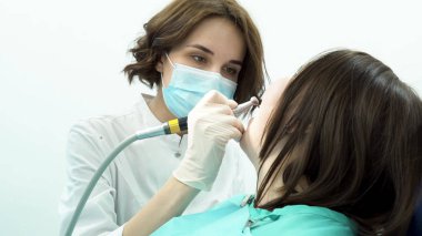 Kadın diş hekimi hastanın dişleri beyazlatır. Medya. Hastalar diş beyazlatma yeni steril stomatology ekipman ile daha önce profesyonel kadın dişçi temizler