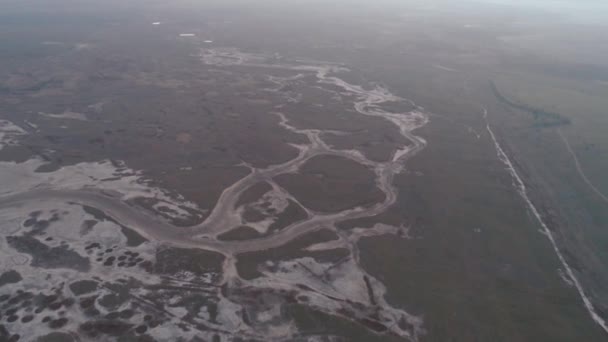 Вид на большую и широкую реку, покрытую льдом и снегом. Выстрел. Прекрасный зимний пейзаж сверху — стоковое видео