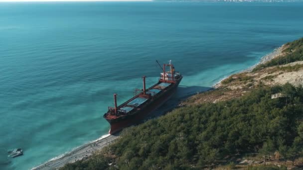 Aerial view of large cargo ship in still blue water near coastline. Shot. Sea transportations — Stock Video