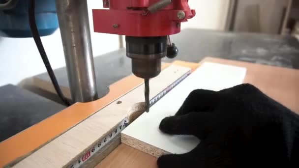 Close up for detail of hands working on drilling machine at the carpentry workshop. Footage. Man hands working with professional tool in the workplace. — Stock Video