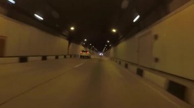 Sarı ışık yolu tüneli görünümünü. Sahne. Güneş beyaz ışık kör önde uzun tünel üzerinden araba çıkar