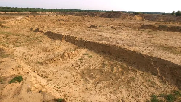 Sand quarry in countryside. Scene. Top view of empty yellow quarry with roads and pits on background of greenery and forest area in summer — Stock Photo, Image