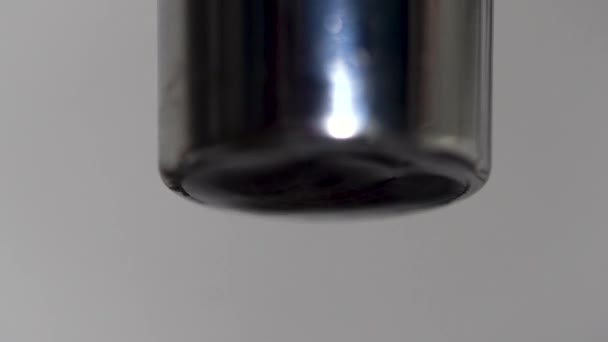 Extreme close up of the faucet and water drops falling down. Media. Leaking silver tap with falling water drops. — Stock Video