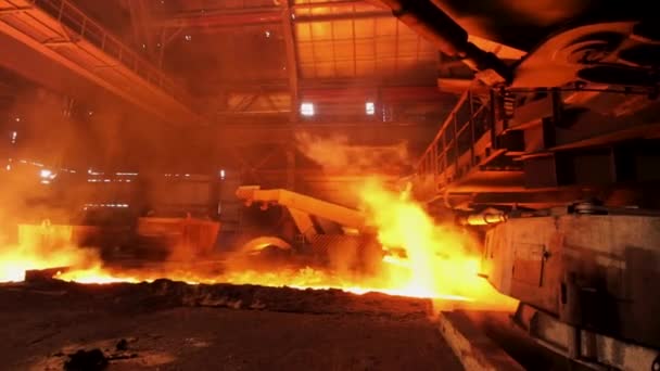 Hot steel being poured to the chute at the steel plant, heavy industry concept. Stock footage. Molten steel production in electric furnaces. — Stock Video