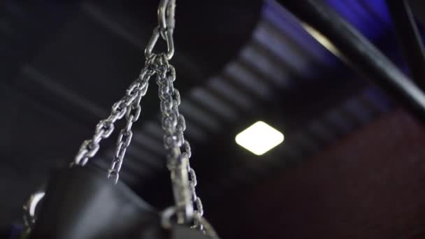 Close-up of swaying punching bags silver chain on black ceiling background. Stock footage. Sports and training — Stock Video