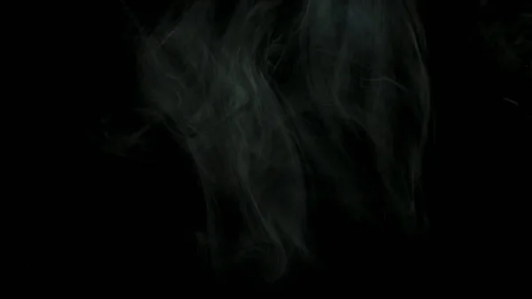 Close up for thick white smoke spreading over black background. Stock footage. Dense fog flying isolated in the dark. — 스톡 사진