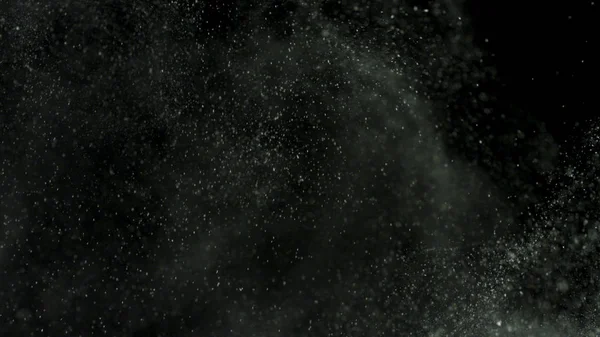 White powder with small particles exploding isolated on black background. Stock footage. White dry inks dust flying into the sides in the dark. — 스톡 사진