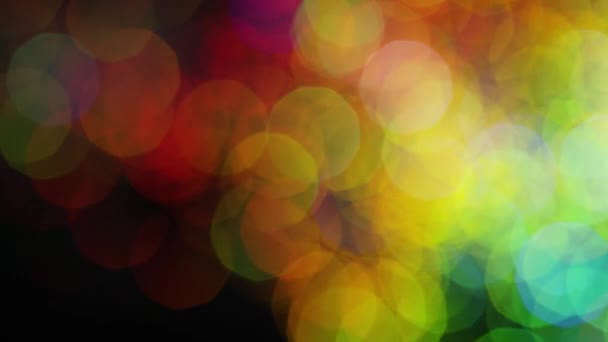 Multicolored spots of shiny bokeh on black background. Stock footage. Colorful bright shiny large bokeh beautifully shine on black background — Stock Video