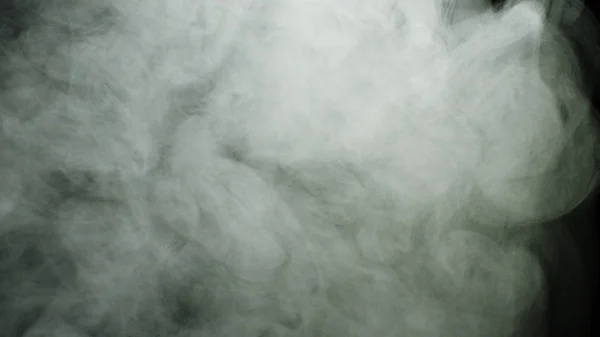 검은 배경에 연기 구름이 퍼져 있습니다. 스톡 푸티지. 시냇물에서 흐르고 검은 색으로 고립된 배경위로 퍼지는 짙은 흰색 연기 구름 — 스톡 사진