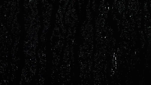 Esőcseppek fröccsenő üveg fekete háttér. Stock Footage. Eső háttér Csepp üvegen terjedő cseppek — Stock Fotó