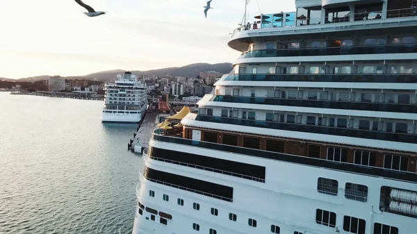 Close up do navio de cruzeiro de volta com cabines e guarda-sóis grandes a bordo, viagens e conceito resort. Estoque. Navio de cruzeiro no porto marítimo com iates brancos, montanha e cidade costeira . — Fotografia de Stock