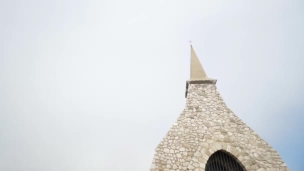 Close-up view of light brick dome with prison lattice against gray cloudy sky. Action. Old church built in Europe — Stock Video